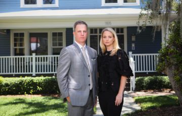 Ben and Amy in front of house