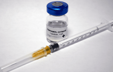 bottle of fentanyl next to syringe