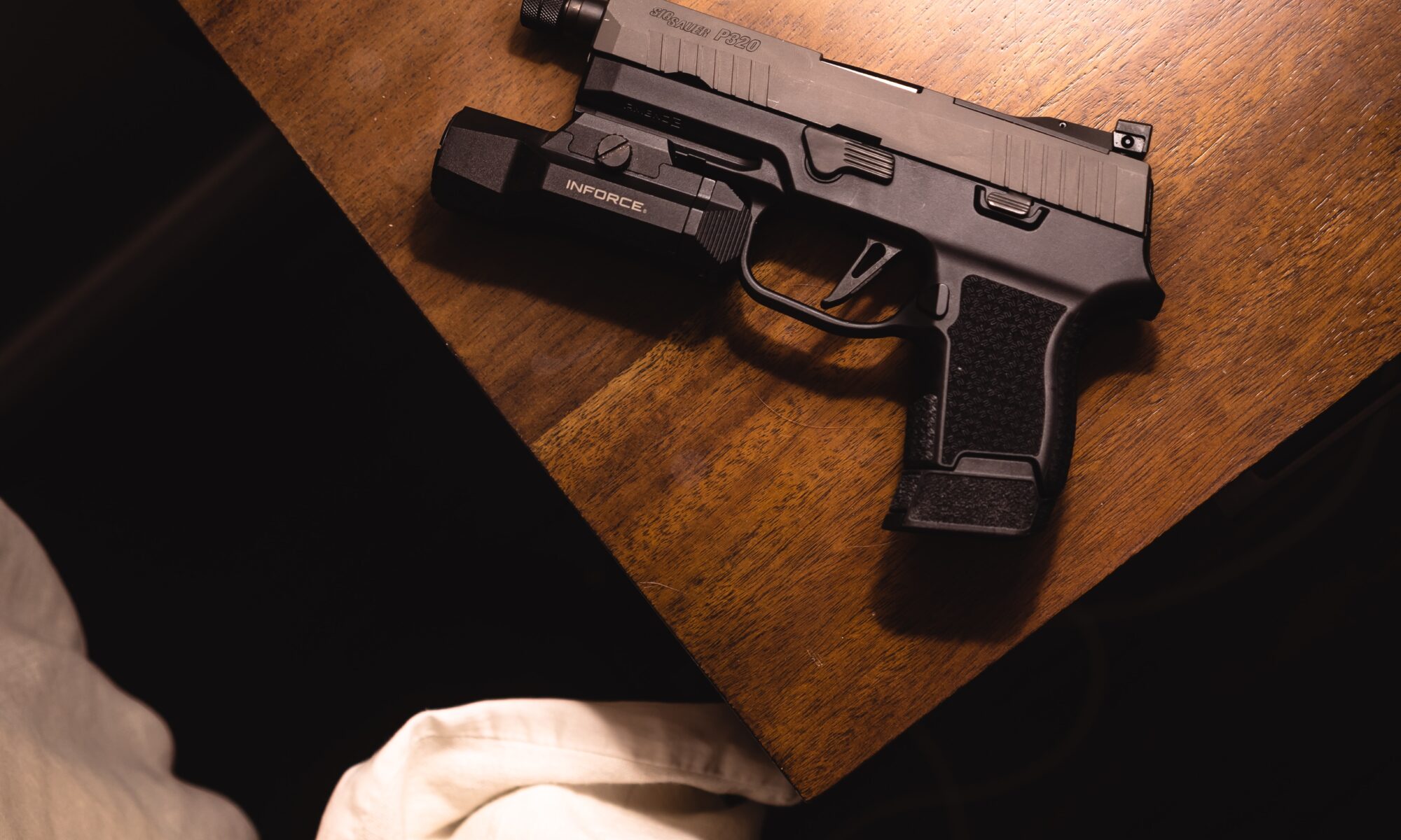 hand gun sitting on bedside table