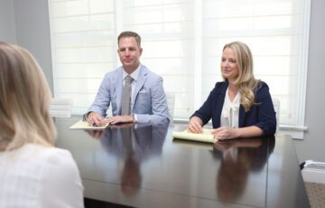 Amy and Ben in conference with client