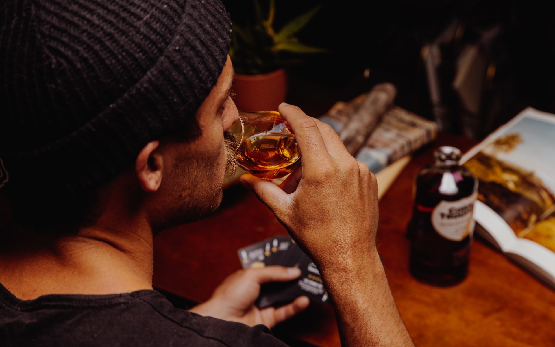 Man drinking alcohol out of shot glass