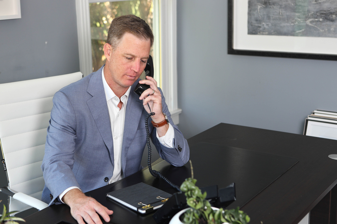 Criminal defense attorney Ben Stechschulte on phone in office