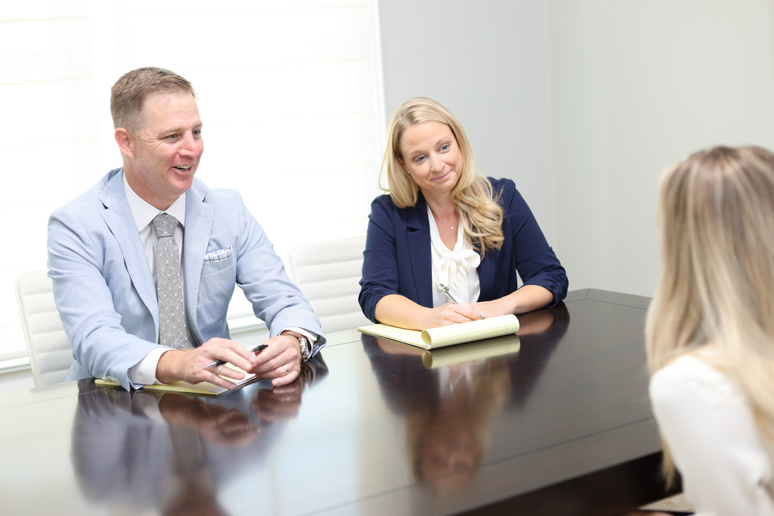 Attorneys Ben and Amy in case review with client