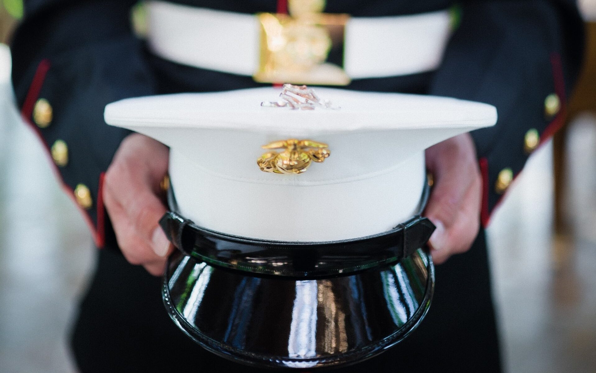Marine Corps service member holding hat
