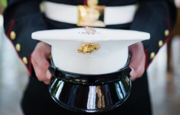 Marine Corps service member holding hat