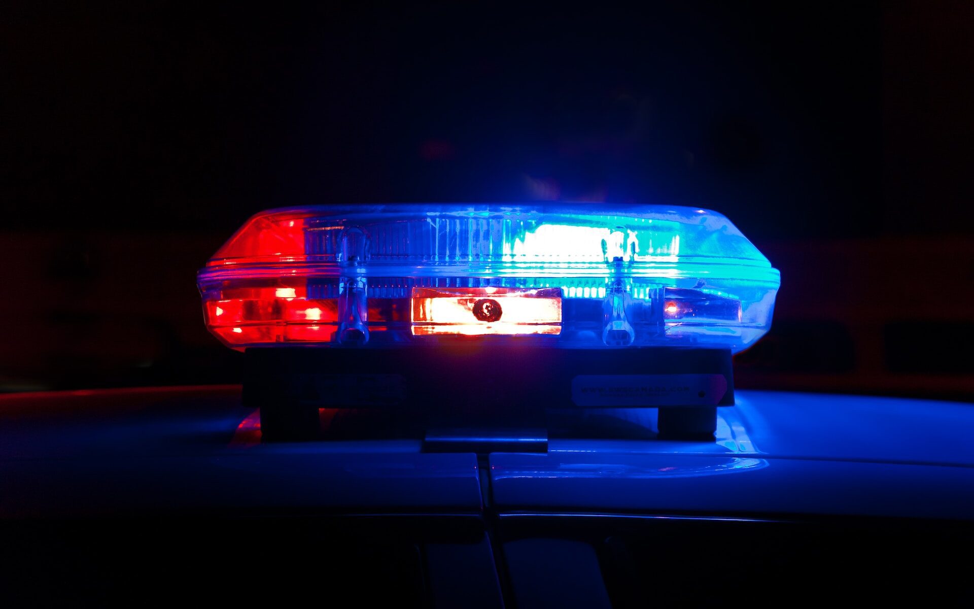 red and blue lights on top of police cruiser