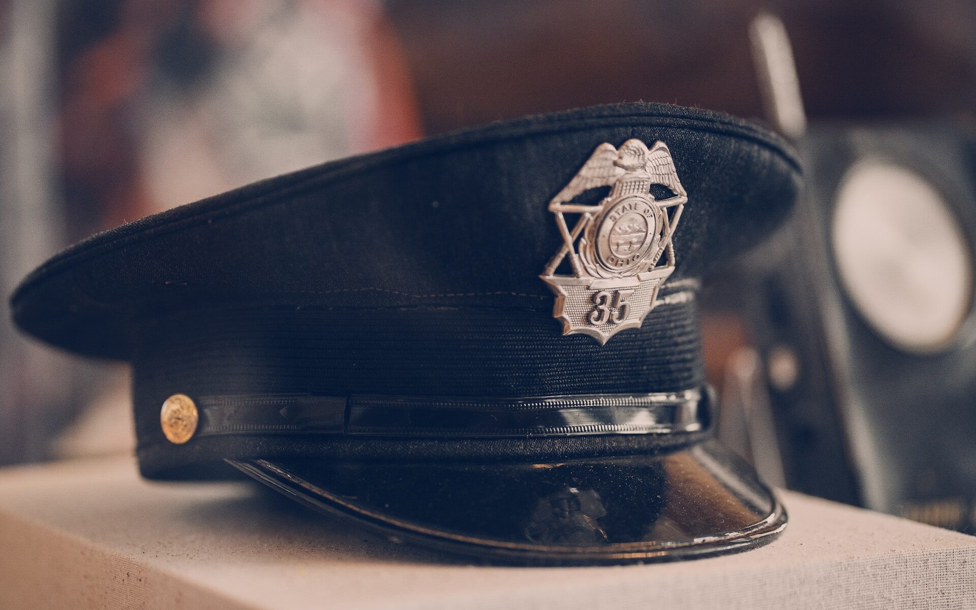 Black police officer hat sitting on desk