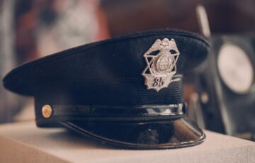 Black police officer hat sitting on desk