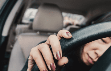 woman asleep behind the wheel DUI