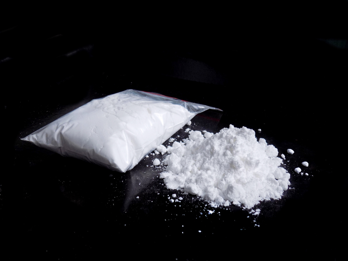Bag of cocaine on black background