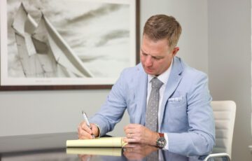 Ben Stechschulte writing on legal pad in office