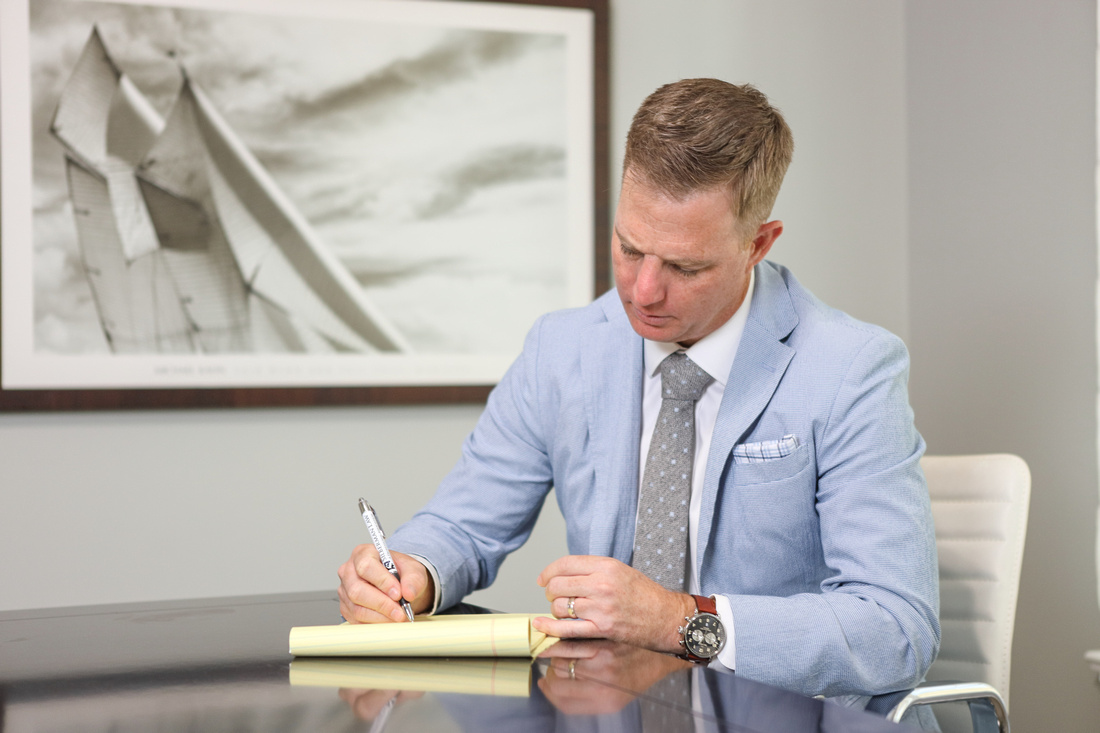 Ben Stechschulte writing on legal pad in office