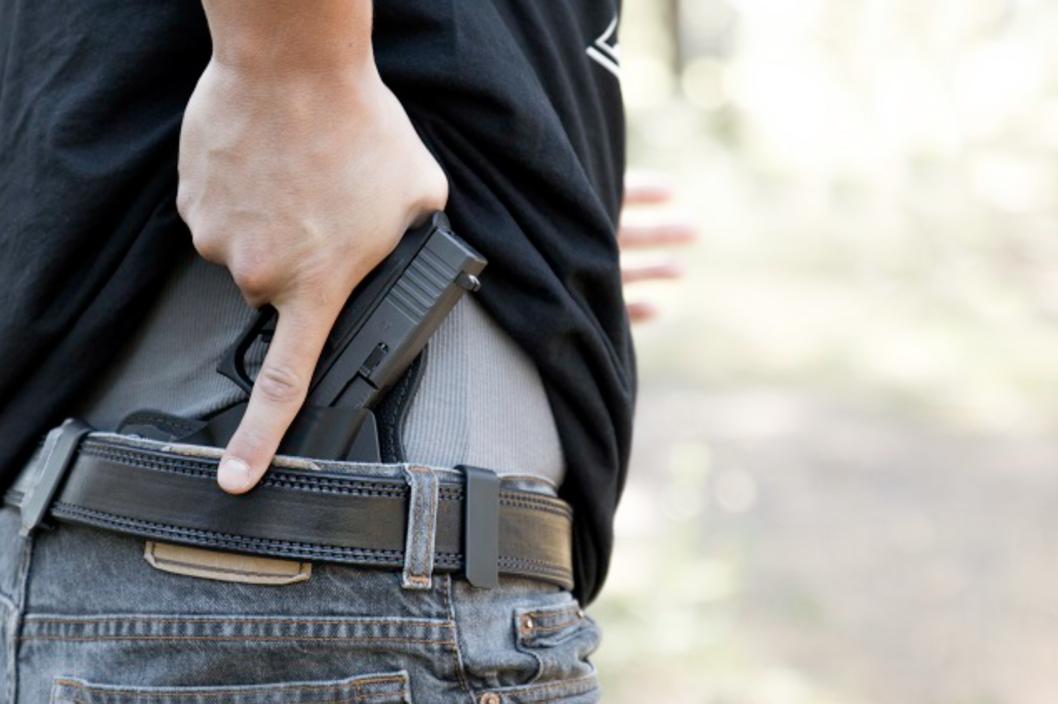 man conceal carrying gun in back of jeans