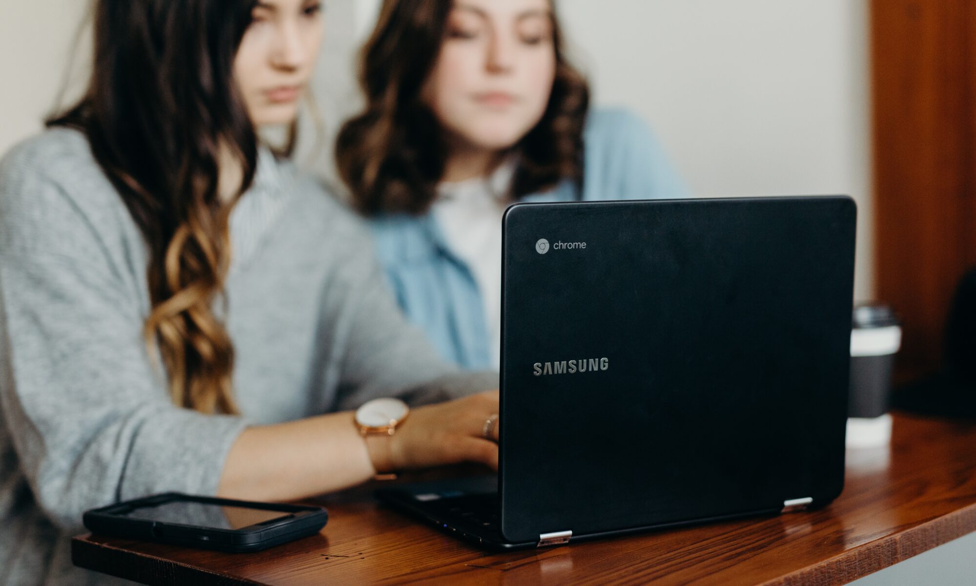 two women looking at computer screen together