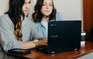 two women looking at computer screen together