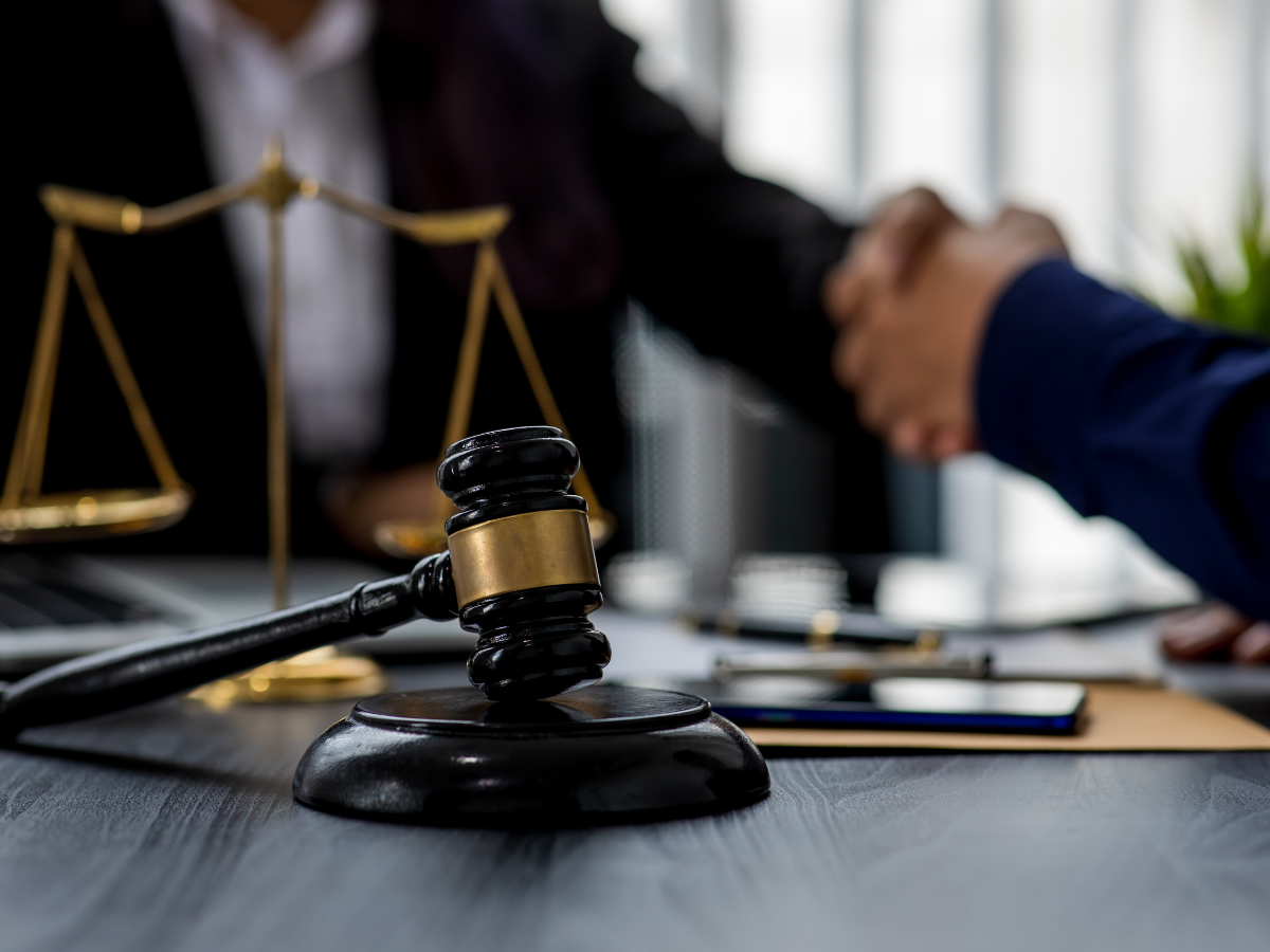 lawyer shaking hands with client in office