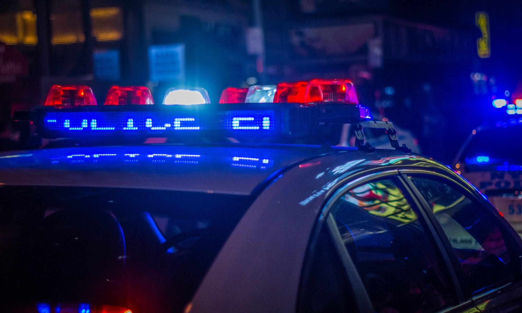 police lights on at night on top of police cruiser