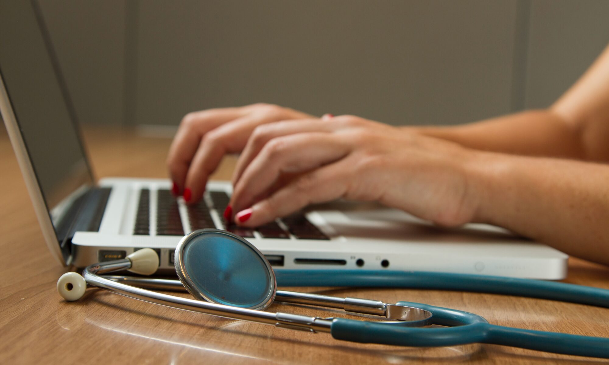 doctor typing at computer