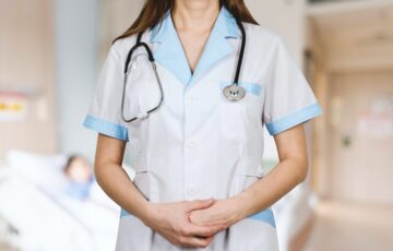 female nurse with hands crossed in front of body