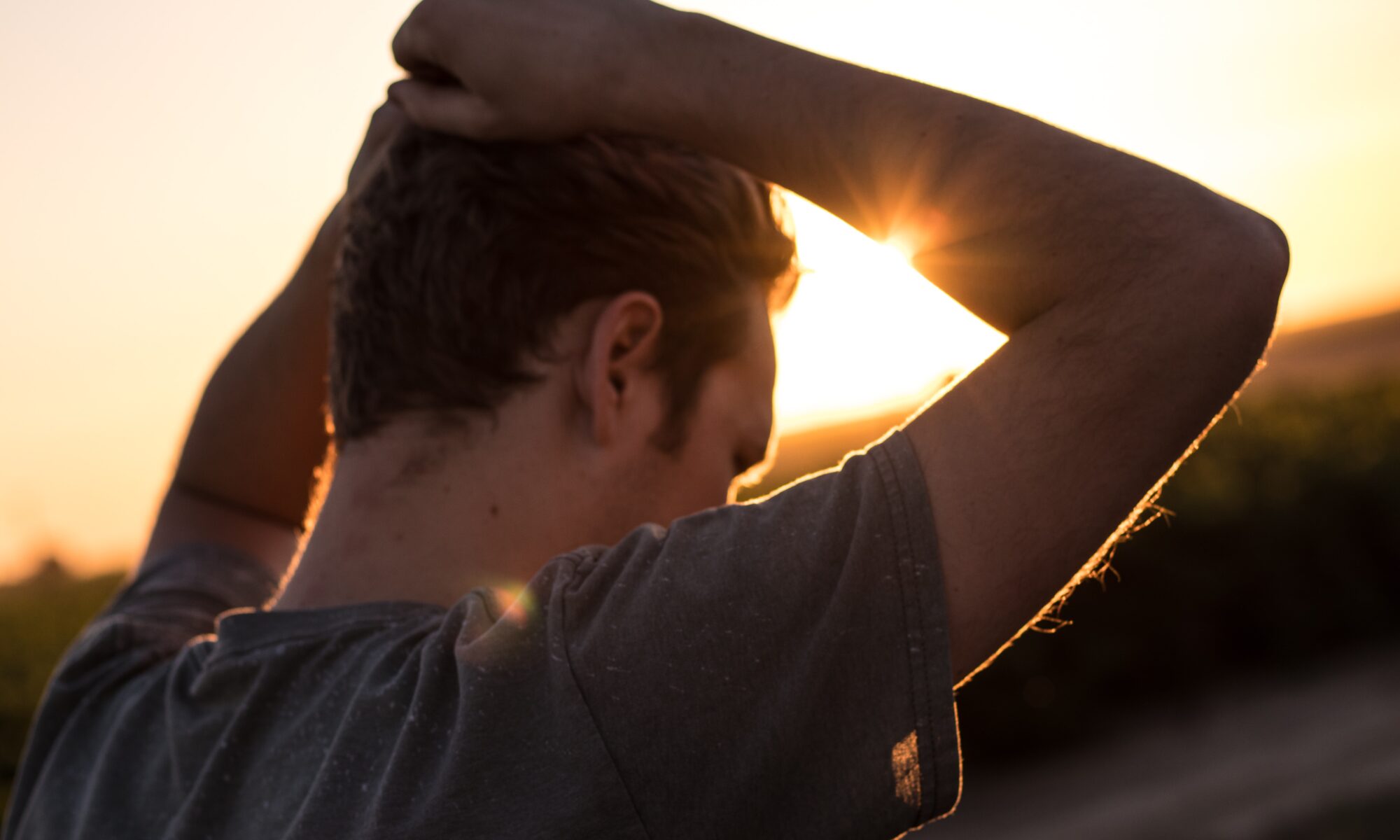 man holding hands above head