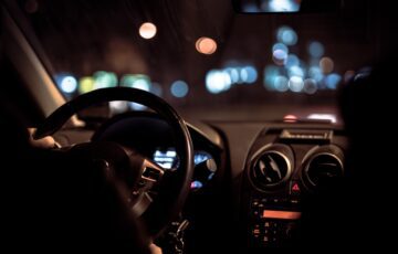 person driving a car at night