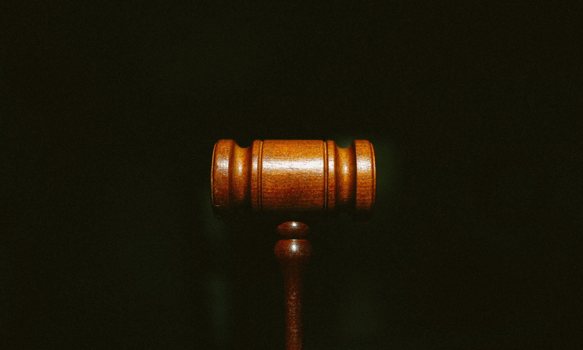 wooden gavel on black background