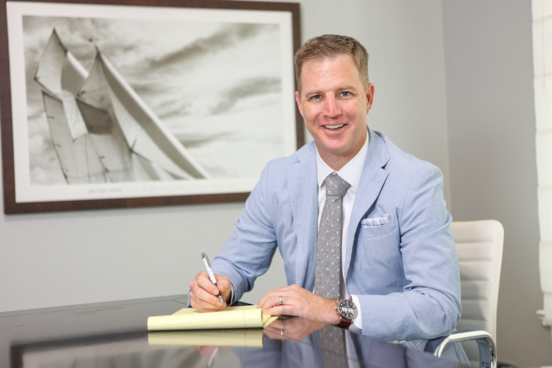 tampa attorney ben stechschulte sitting at a desk looking into the camera smiling