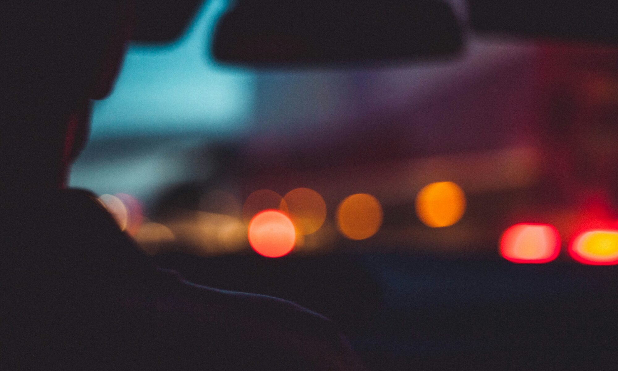 man driving car at night