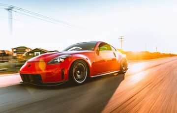 red Ferrari driving down the road