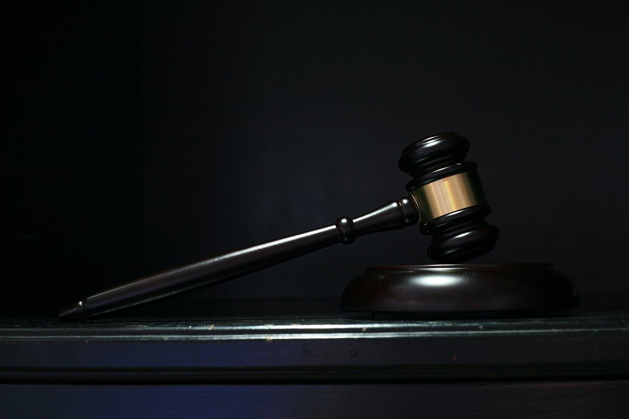 dark brown gavel against black background on desk